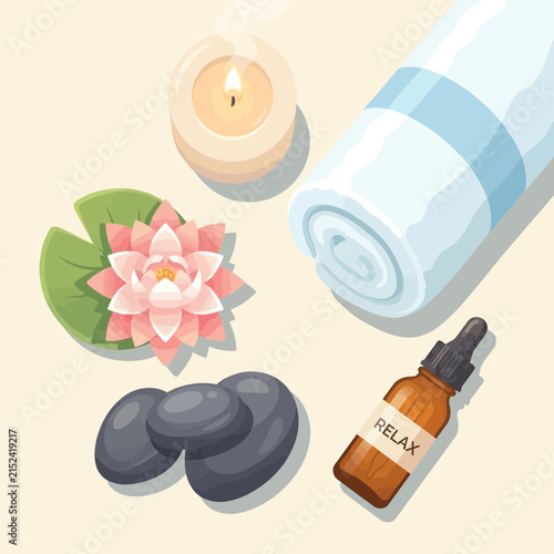 Spa wellness items with candle and lotus flower.