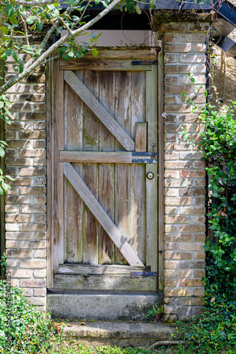 Old Wooden Door and Brick Wall on the Side of an Historic Residence