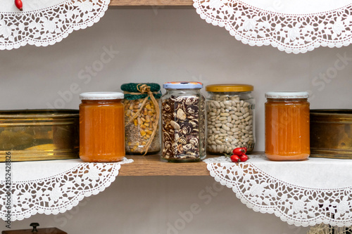 Rustic kitchen shelf with jars and kitchen ingredients