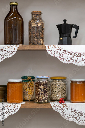 Rustic kitchen shelf with jars and kitchen ingredients