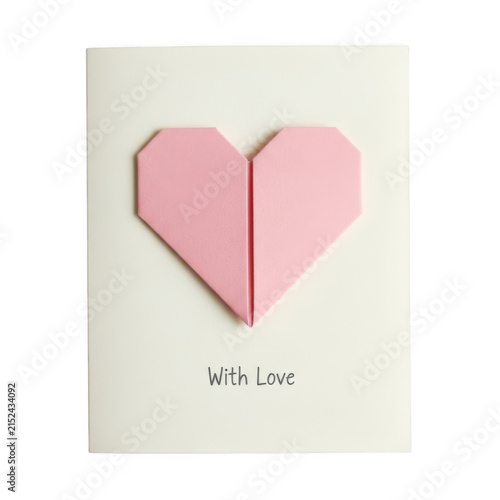 Pink origami paper heart on a greeting card