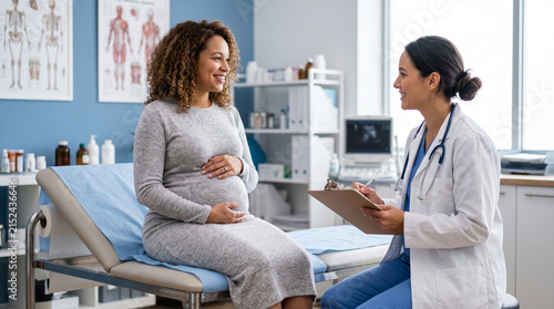 Pregnant woman smiling during a medical checkup with a doctor