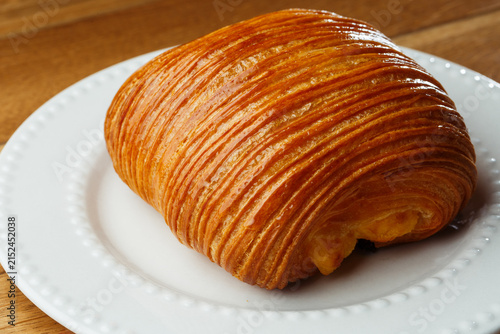 Принти на полотні Close-up of freshly baked laminated pastry with shiny golden crust, creamy filli