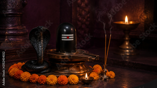 Atmospheric indoor temple shrine showing a holy black shiv lingam and a dark stone snake statue with incense smoke for nag panchami