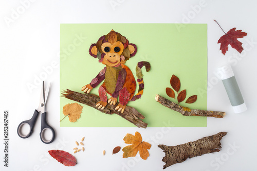 Photography Monkey made from autumn leaves on branch with scissors and glue