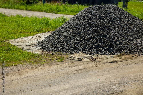 Obraz na płótnie Big pile of crushed stone gravel on geotextile fabric by countryside road