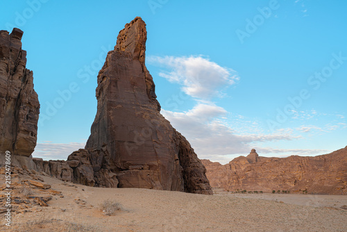 Tall sharp sandstone rocky formations in Al Ula desert, afternoon sky background