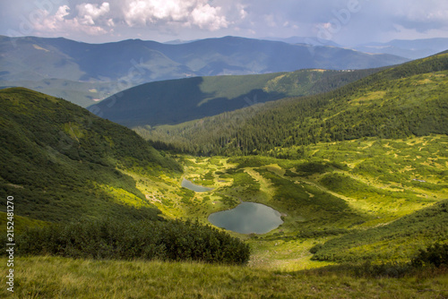 Serene mountain landscape with twin lakes nestled in lush green valleys