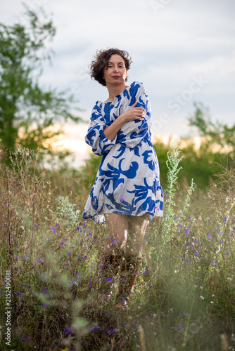 Woman in Blue Floral Dress Standing in Wildflower Field