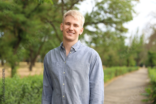 Portrait of smiling man wearing shirt in park
