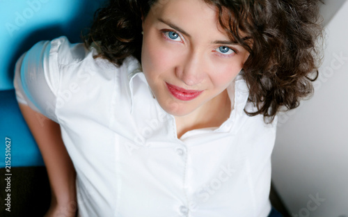Attractive female model with bright blue eyes close up.	
