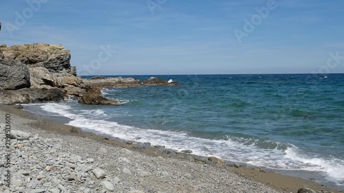Mediterranean seascape in Southern France with rocks, beach and waves
