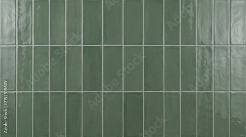 Deep sage green glazed ceramic wall tile texture with subtle surface variations