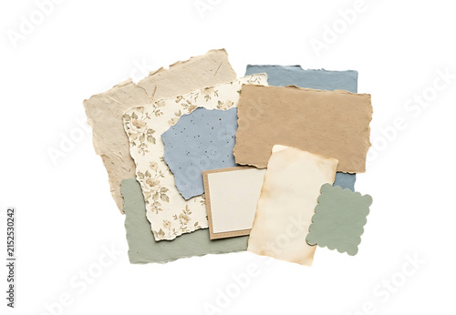 A collection of various vintage paper scraps and textured craft sheets in neutral colors isolated on transparent background