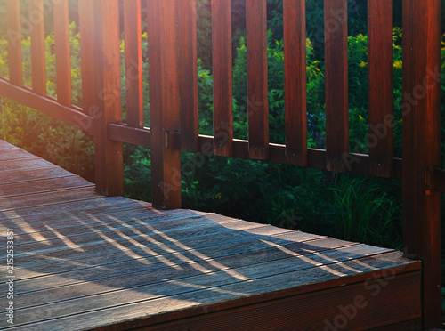 Dramatic light falling on wooden stairs in city park