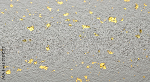 Sparkling gold flakes on textured gray background