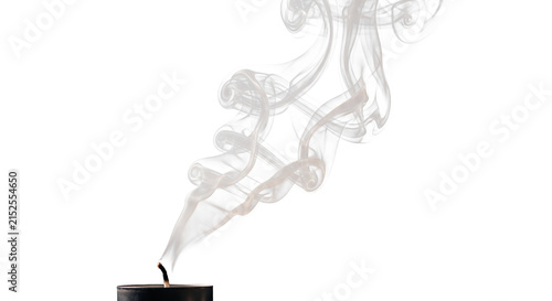 Quadro su tela Delicate wisps of smoke curl upwards from a extinguished black candle