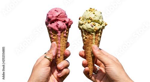 Fotografie Two hands holding ice cream cones with melting scoops on a white background