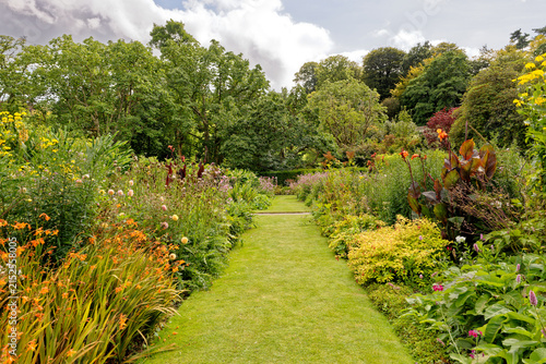 Vibrant Mixed Flower Herbaceous Border Along Curved Grass Path
