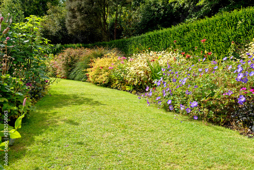 Vibrant Mixed Flower Herbaceous Border Along Curved Grass Path