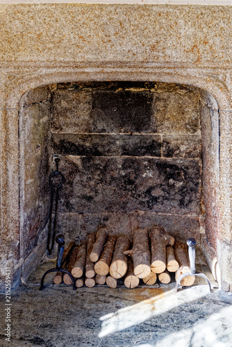 Historic Granite Fireplace Hearth Stacked with Firewood Logs