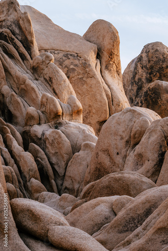 Dramatic granite rock formations illuminated by warm evening light in Joshua Tree National Park, California