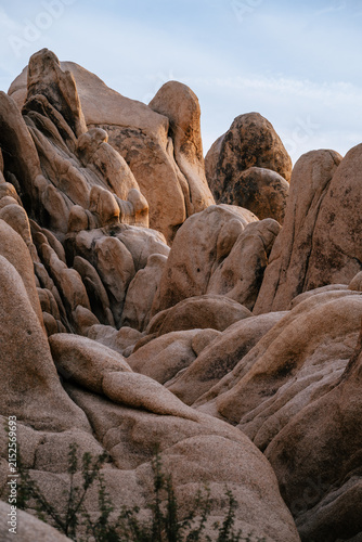 Dramatic granite rock formations illuminated by warm evening light in Joshua Tree National Park, California