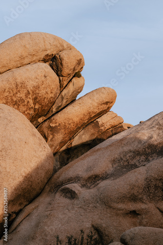 Dramatic granite rock formations illuminated by warm evening light in Joshua Tree National Park, California