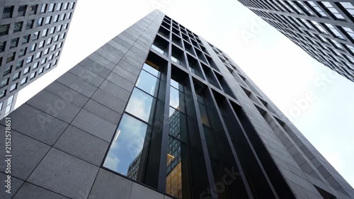 Modern Corporate Facade with Grey Stone and Glass Reflections ideal for business presentations and real estate marketing.