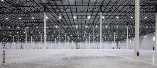 Modern Empty Distribution Warehouse with High Ceilings and Industrial Lighting