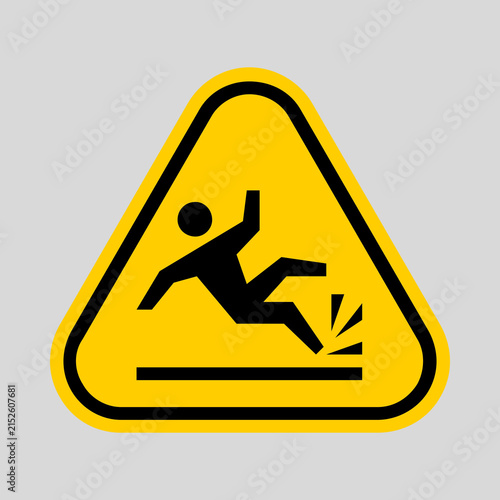 Cuadro en lienzo Yellow triangular warning sign depicting a person falling onto a hard surface, indicating a slip, trip, or fall hazard