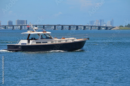 Vintage Motor Yacht on the Florida Intracoastal Waterway with the Julia Tuttle Causeway bridge in the background.