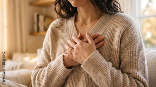 Woman holding hands on chest with heartfelt expression gratitude touching mindfulness wellness