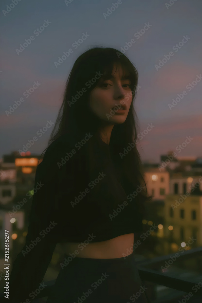 Fototapeta premium Young Woman in City at Dusk