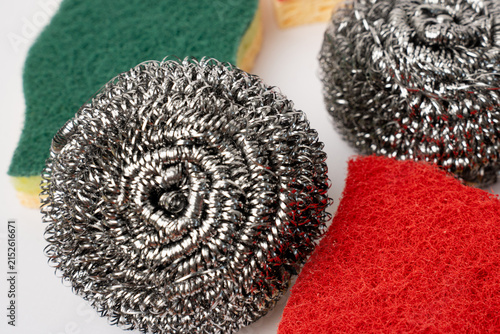 Steel wool scrapers and colorful kitchen sponges on white background.
