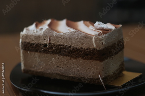 Принти на полотні Rich Chocolate Cake Slice on Dark Plate in Warm Lighting