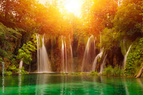 Scenic waterfall in lush forest setting at sunrise with waterfall landscape cascades environment tranquil peaceful