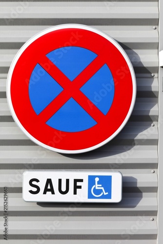 No stopping or parking road sign on a wall except for people with disabilities in France