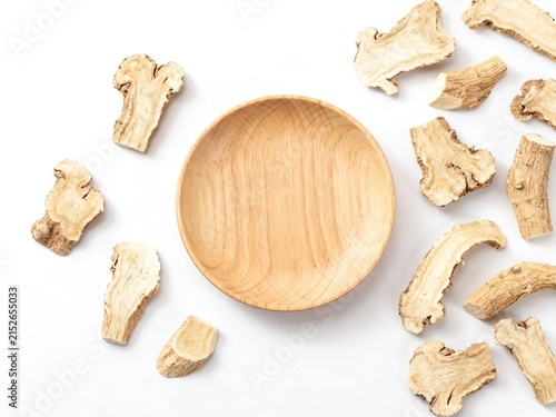 Herbal tea ingredients in wooden bowl on white background