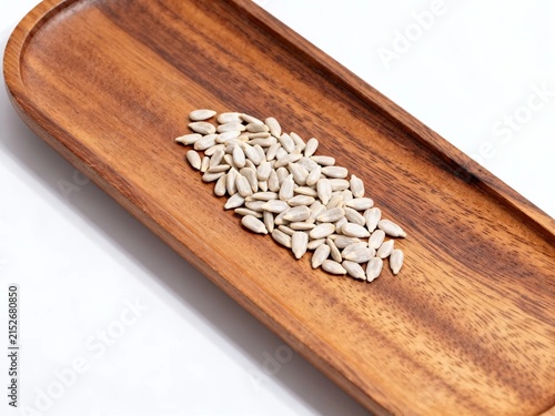 Raw pumpkin seeds on wooden cutting board