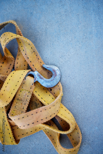 Close up of a Used Web Towing or Lifting Strap with steel hook
