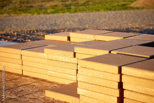 Stack of Patio Blocks sitting on a Plywood and a Cement Pad