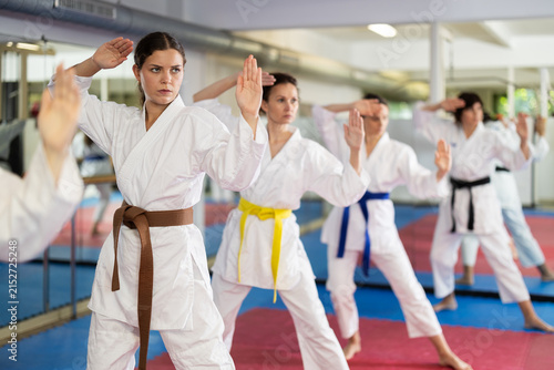 Photography Women athletes learn practice of kata karate punches, hone fighting skills by repeated repetition