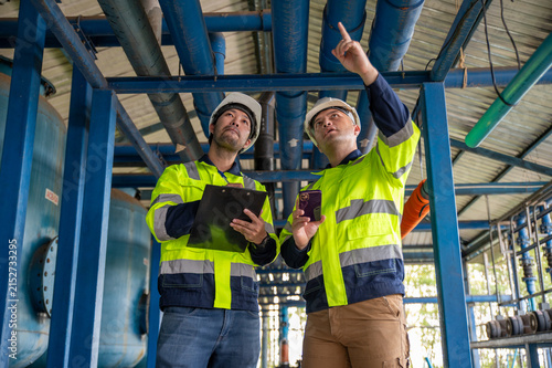 Expert engineers and inspectors are jointly examining the overall operation of the large water treatment plant.