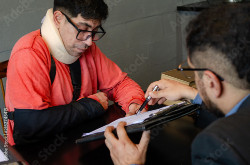 Cuadro en lienzo Personal Injury Lawyer Pointing at Claim Document for Injured Client
