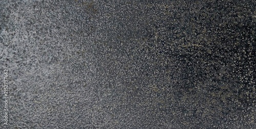 Obraz na plátně Dark grey rough stone surface texture background, close up grainy charcoal granite or concrete background
