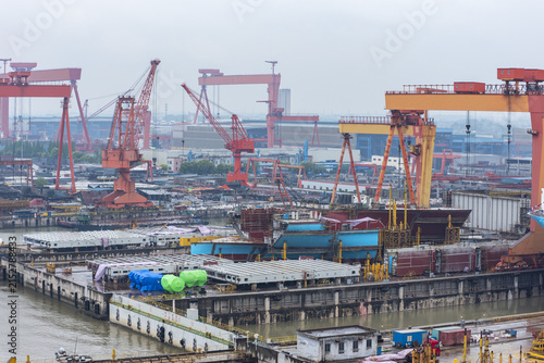 Canvas Print Wide view of shipyard infrastructure near Shanghai, showing vessels under construction and large port cranes