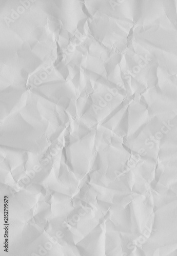 фотографія Clean empty white crumpled paper sheet for abstract background or texture in vertical orientation, creased blank page with random wrinkles and folds, top view