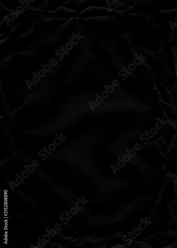 Foto Expansive dark crumpled black paper sheet texture with subtle edge creases and smooth central area, ideal for elegant backgrounds or refined design elements