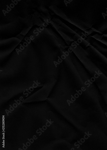 Obraz na płótnie Black paper texture with subtle folds and creases provides a dramatic background, ideal for dark-themed graphic design projects and product photography